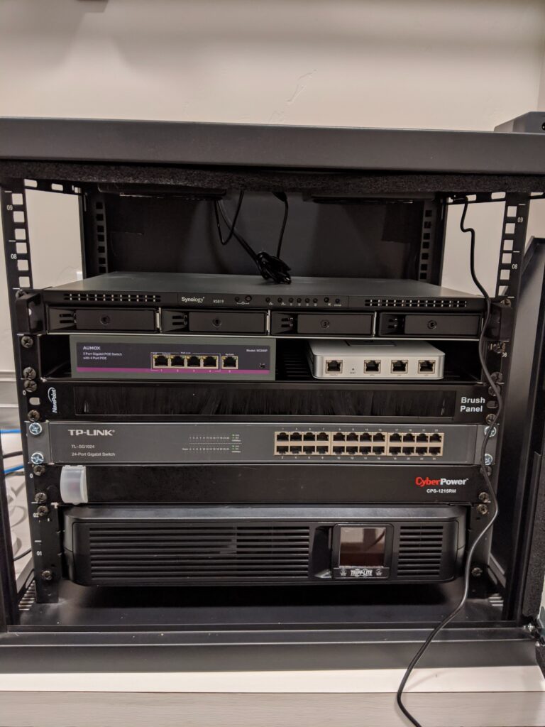 A photo of an in-progress build of my old server rack (missing a couple pieces of hardware).
